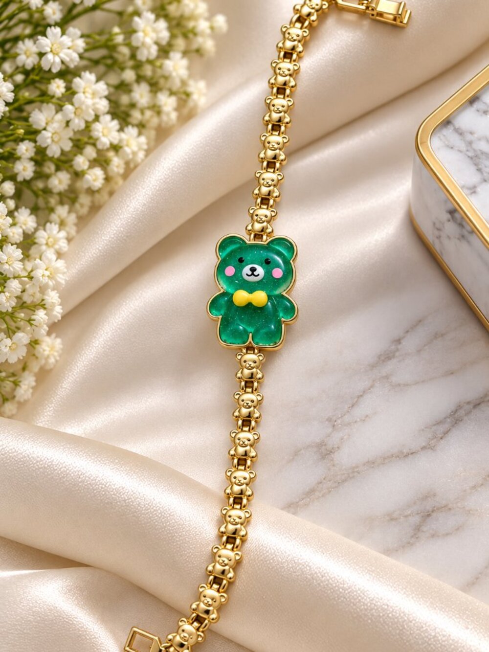 Bracelet featuring adorable teddy bear links and a sparkling emerald-green teddy